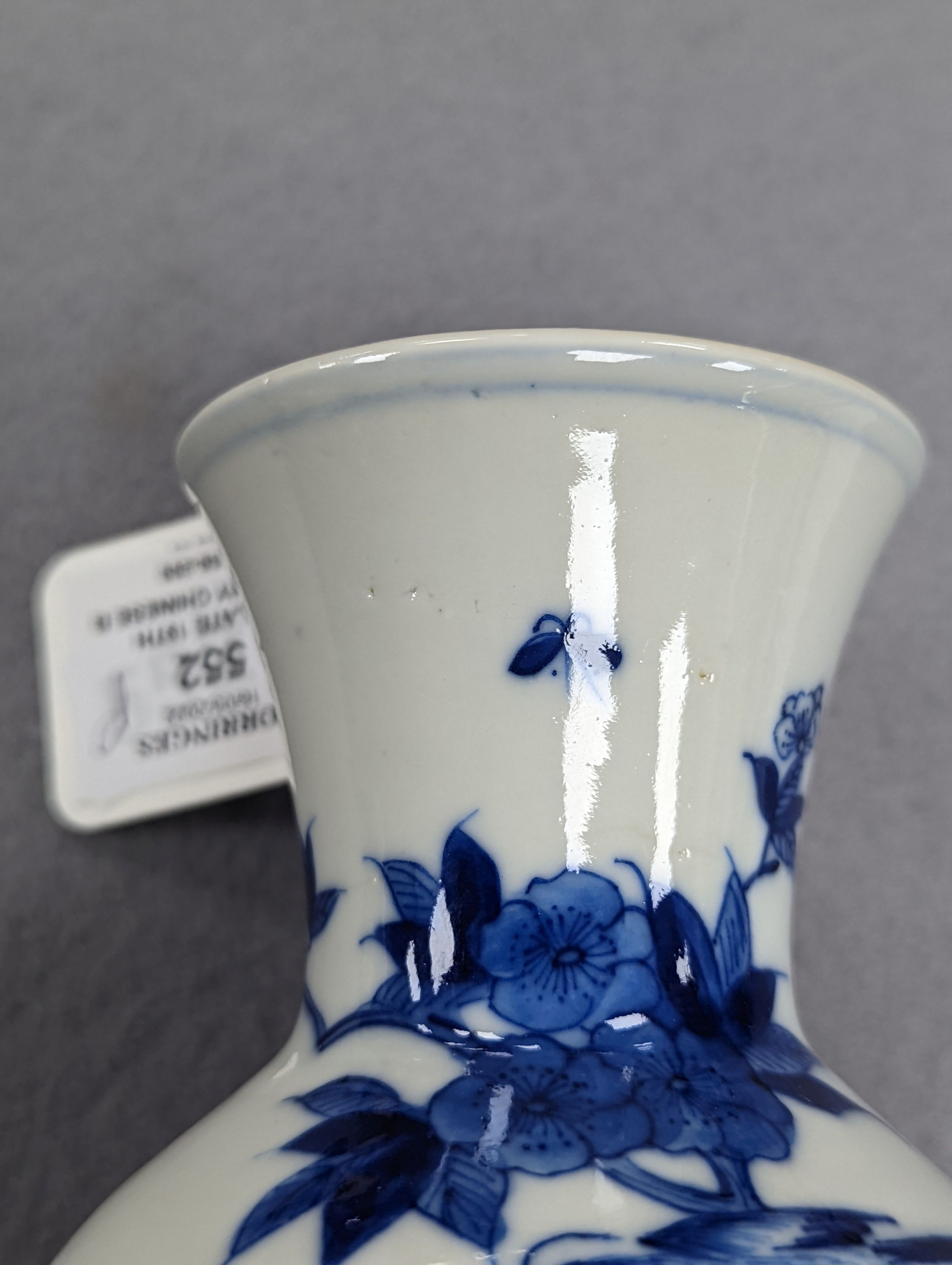 A late 19th century Chinese blue and white baluster vase, painted with birds amid flowers and rock work, pseudo Kangxi mark. 26cm